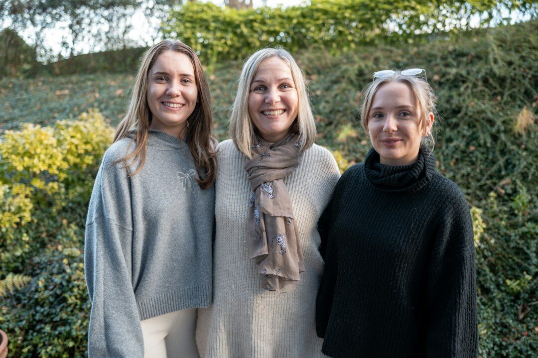 Portrait of the boutique's founding team standing together in the atelier