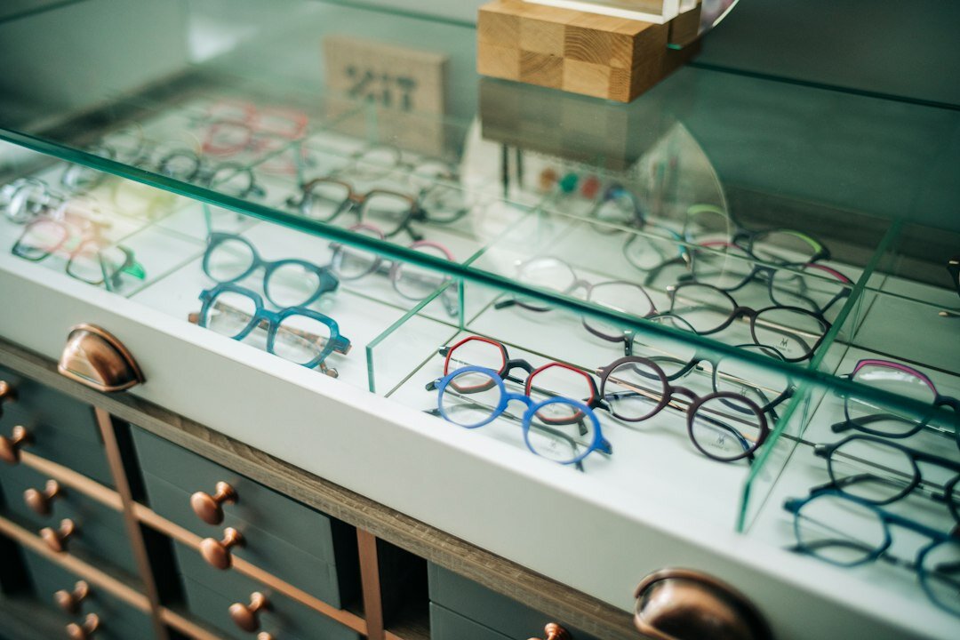Certified optometrist fitting eyewear frames for a client in a private atelier