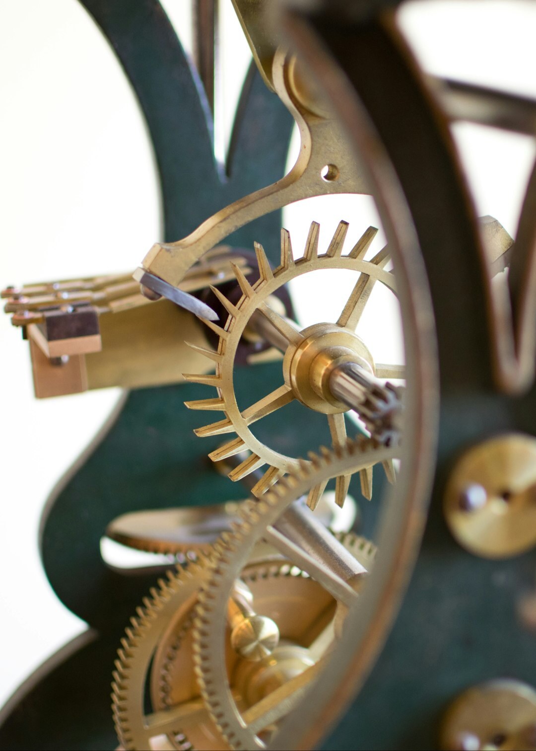 Macro photograph of a Swiss tourbillon watch movement with gold bridges