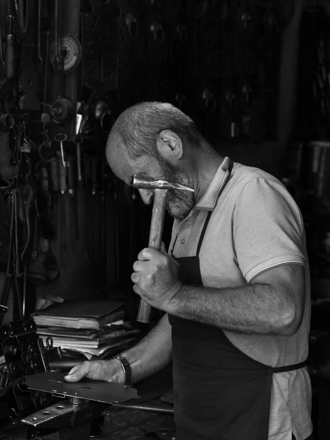 Artisan hand-carving a luxury acetate eyewear frame in a workshop