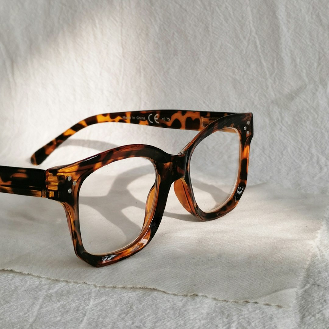 Studio product photograph of tortoiseshell acetate designer eyeglass frames